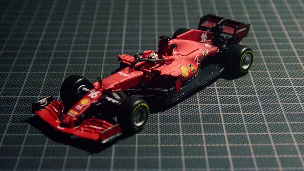 Red Formula 1 scale model on a cutting mat