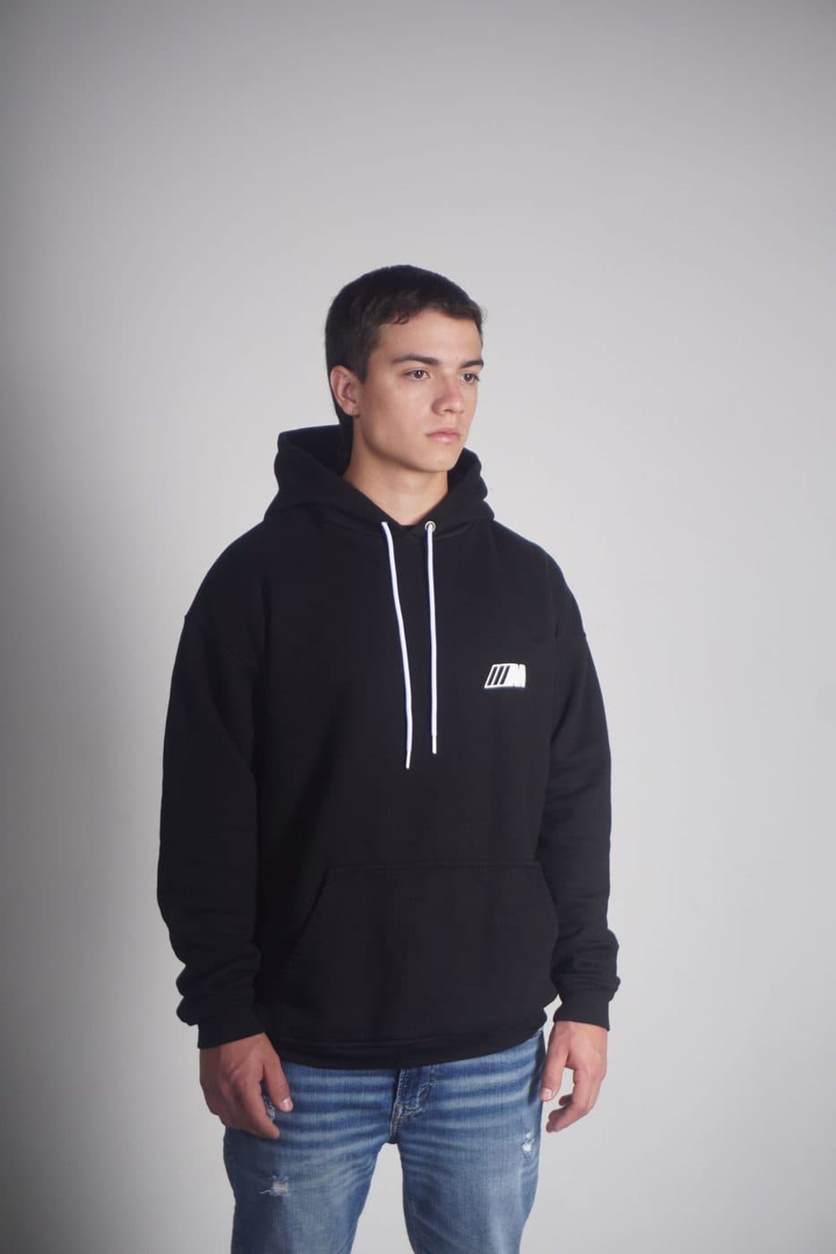 Black pullover hoodie against a grey background
