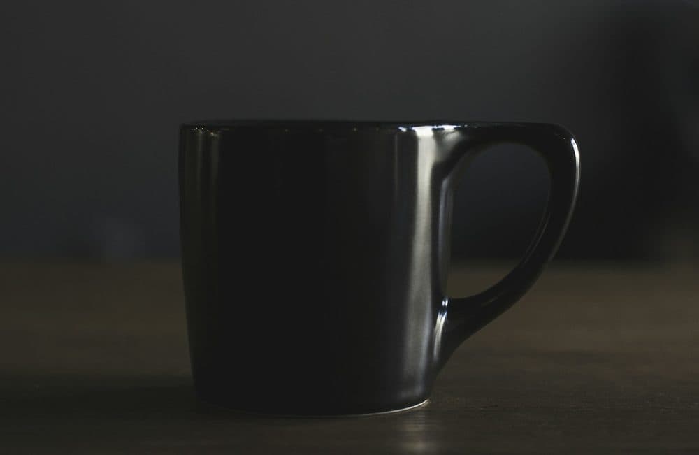 Black ceramic mug on a dark background