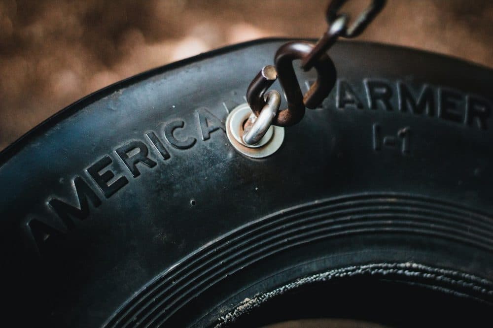 Metal key ring resting on a rubber tyre