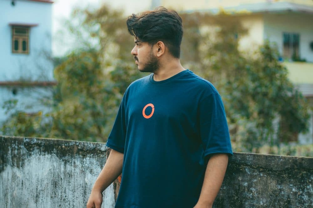 Blue crew-neck t-shirt worn outdoors